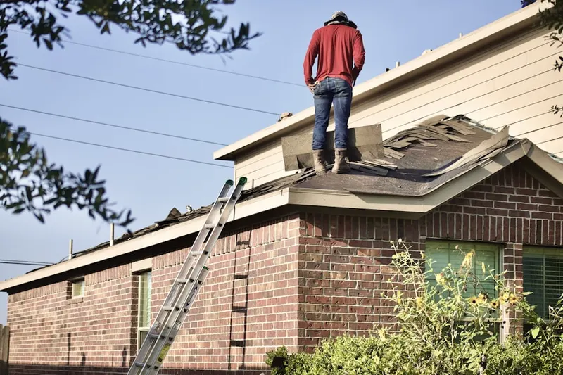Professional roofer working on a residential roof in Underwood Hills